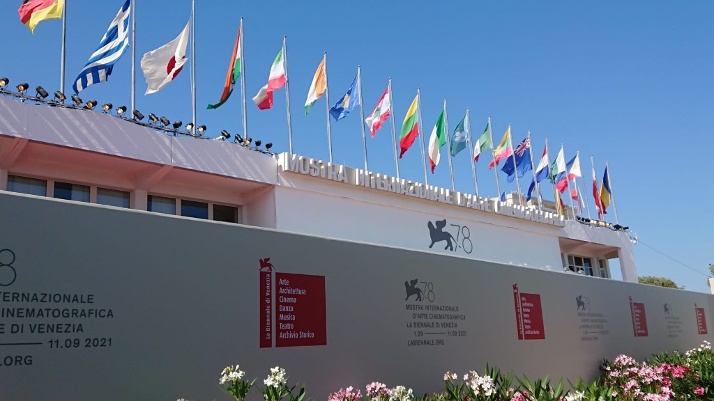 Photo of the Cinema Building in Venice with triangular flags around it